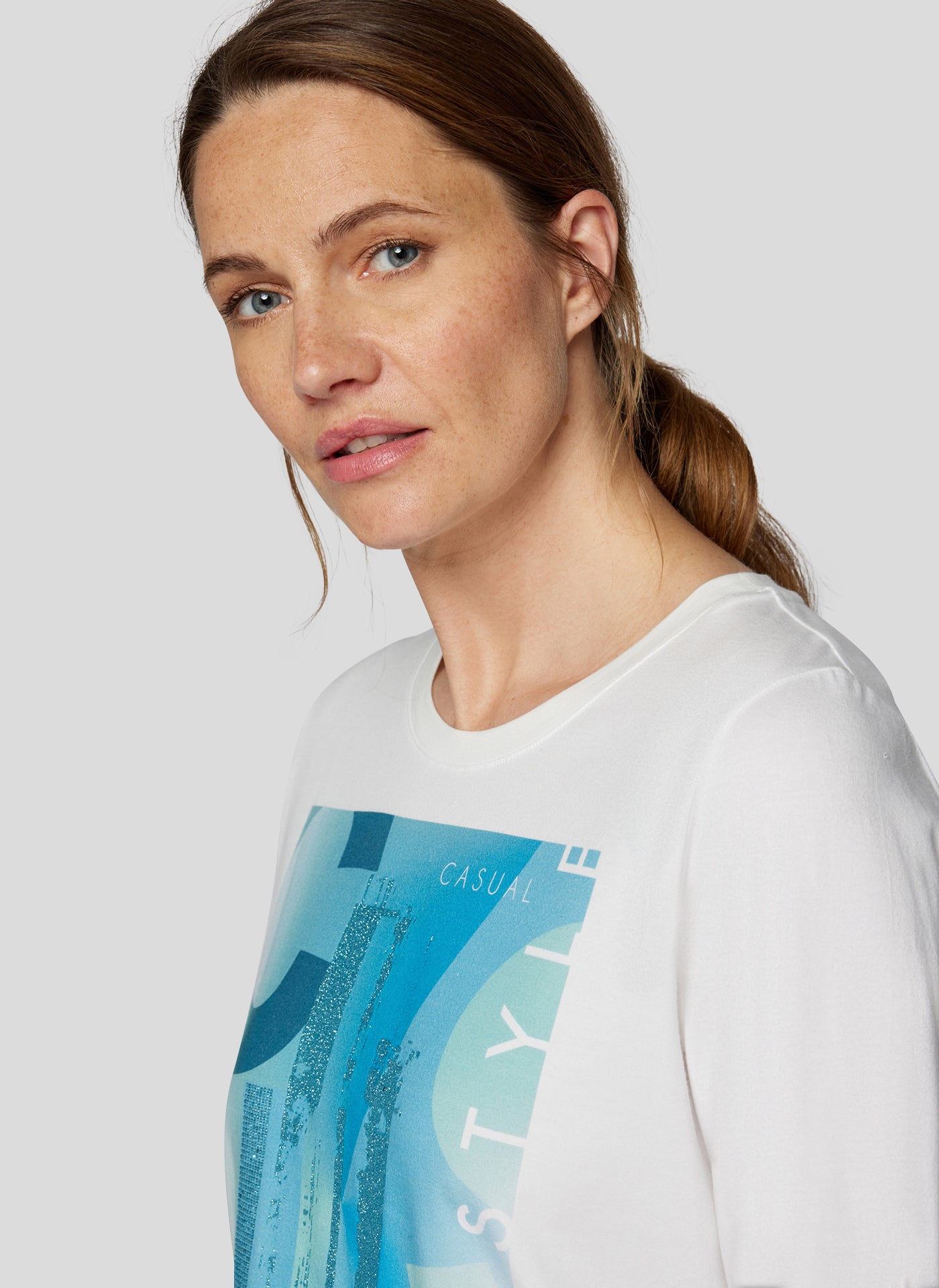 Cream Long Sleeve Top with Peacock Blue Graphic Print